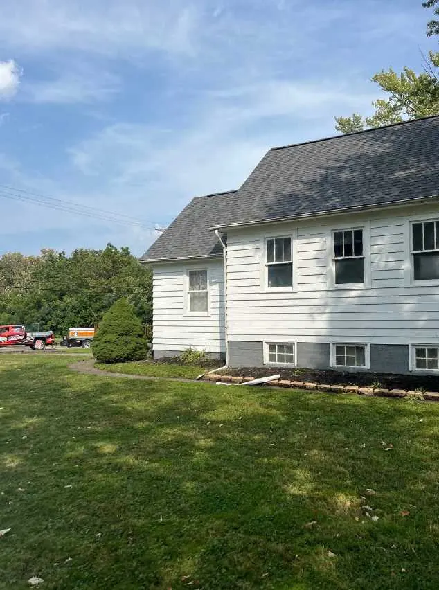 Completed roof replacement with gutters by Razo Brothers Roofing