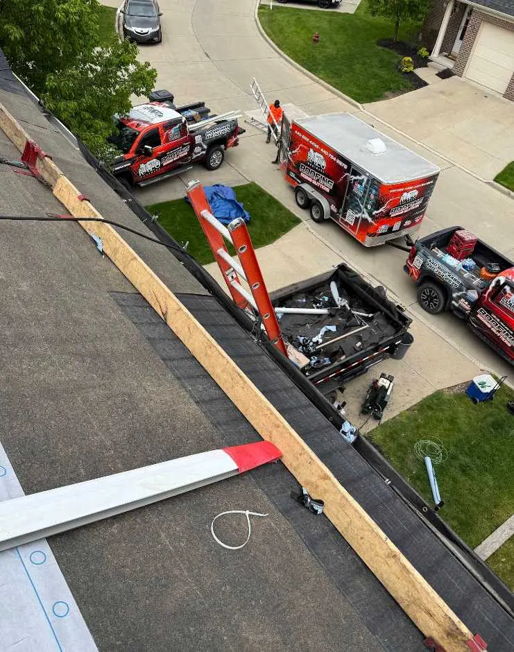 Razo Brothers Roofing crew setting up equipment on a job site